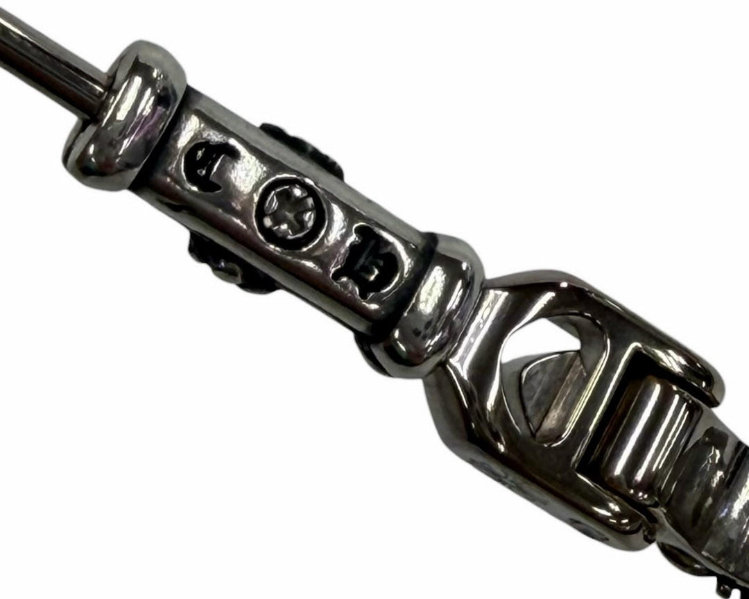 Close-up of a silver chain bracelet on a white background