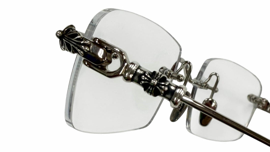 Clear eyeglasses with decorative metal frame on a white background