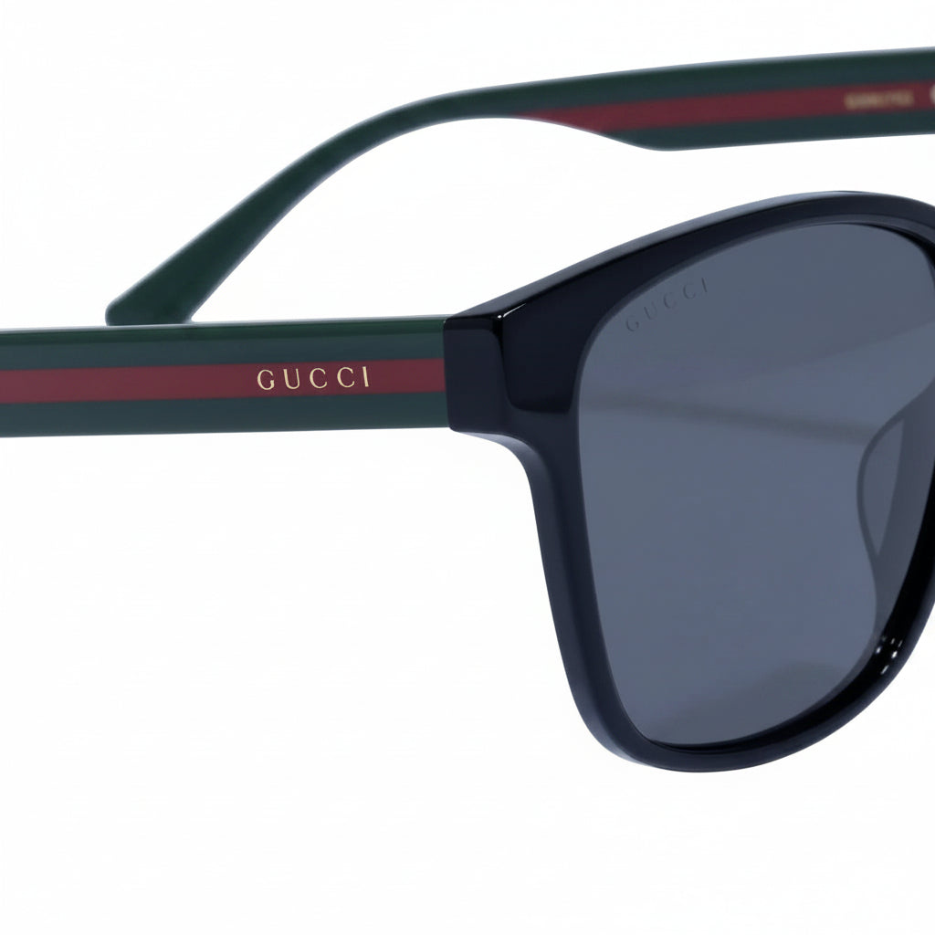 Gucci sunglasses with dark lenses and green and red frame on a white background