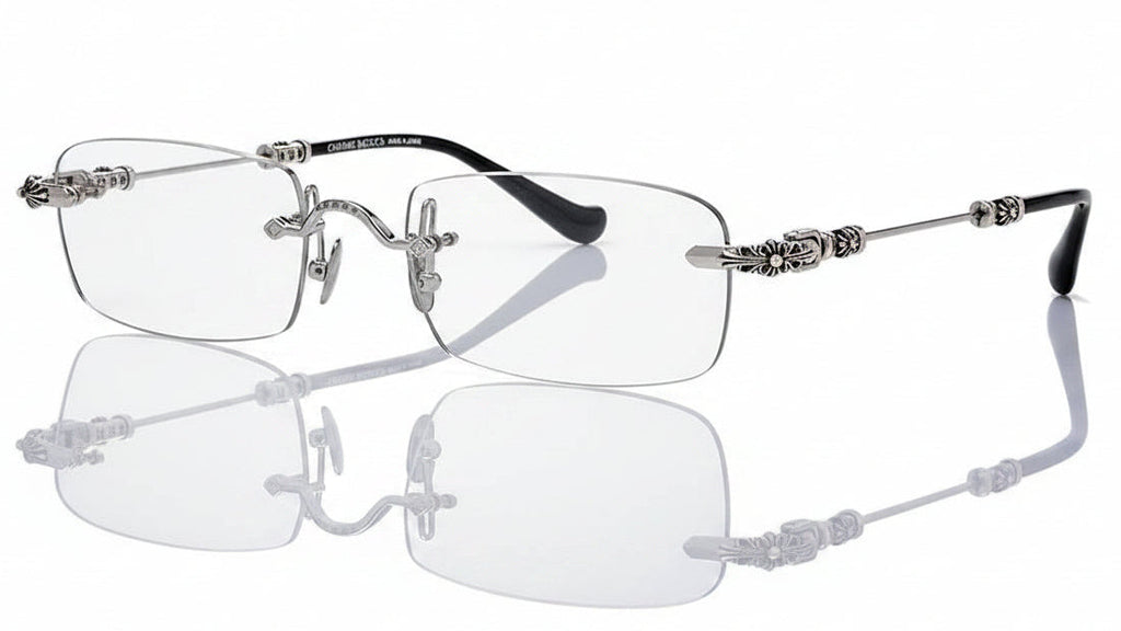 Silver-rimmed eyeglasses with decorative arms on a white background