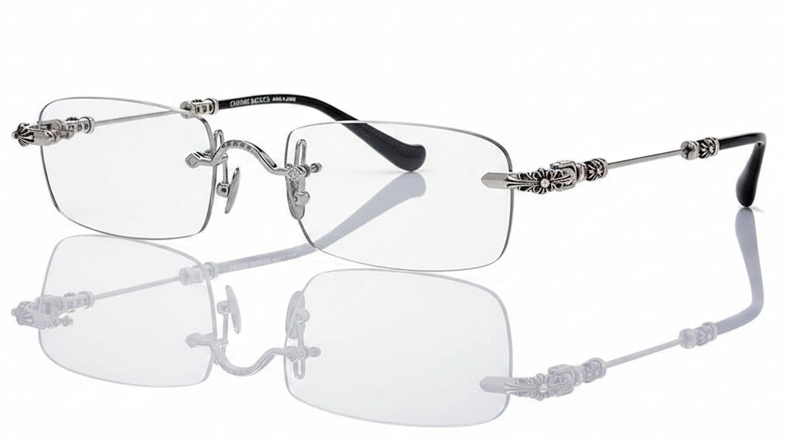 Silver-rimmed eyeglasses with decorative arms on a white background
